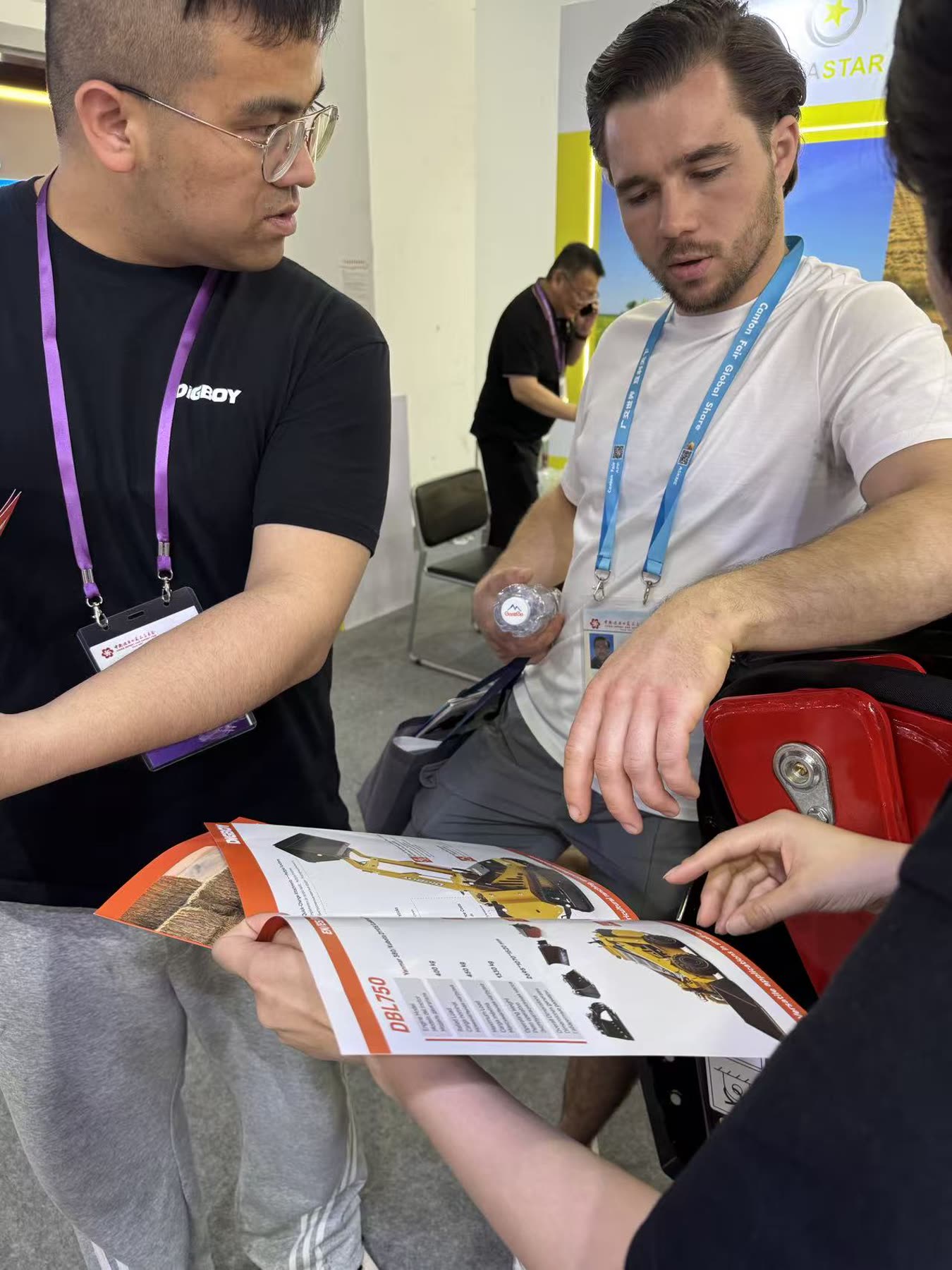 DIG-BOY team explaining loader brochure details to a buyer